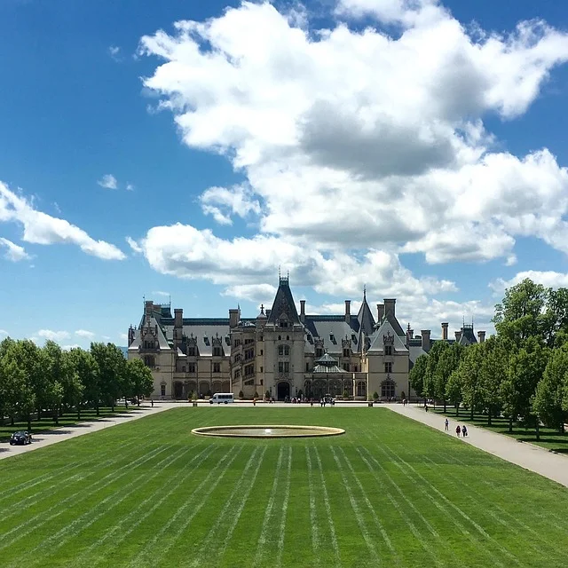Iconic summer landscape at Biltmore Estate in Asheville, NC, with grand lawn, fountain, and symmetrical tree lines