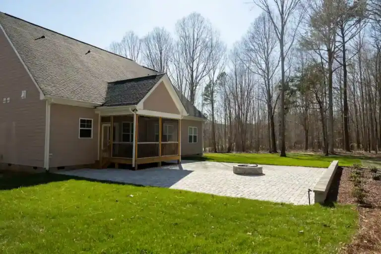 Paver patio, fire pit, retaining wall and landscape lighting for a Rolesville, NC backyard