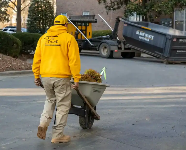 Turf TitanZ crew member moving plants for a landscape design and installation project in Rolesville, NC