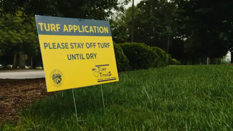 Turf TitanZ turf treatment sign placed on a maintained lawn as part of seasonal lawn care in Rolesville, NC